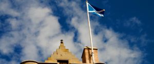 scottish flag and castle ramparts against blue sky