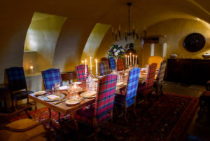 dramatic dining room with tartan chairs